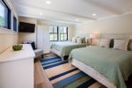 Bedroom with two queen beds, dresser and 40 flatscreen TV